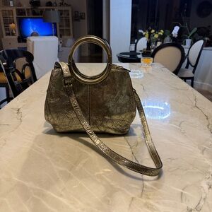 Patricia Nash Metallic leather handbag with crossbody strap.